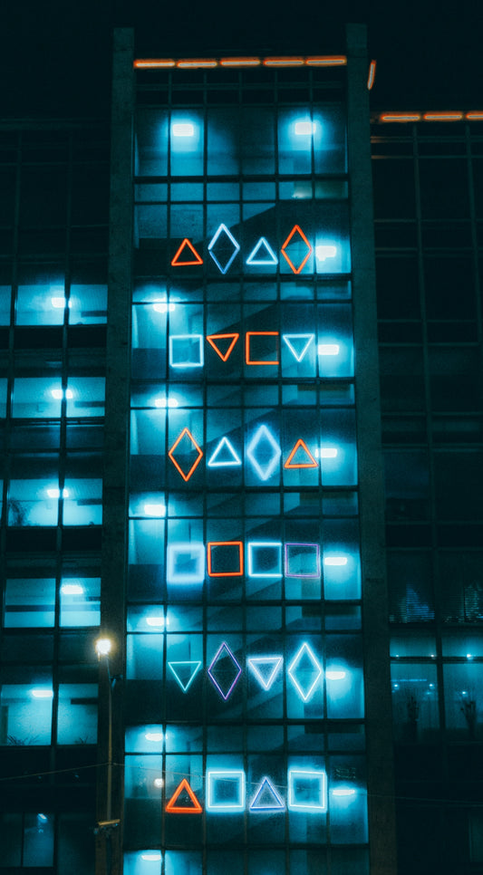 blue and black building with lights turned on during night time